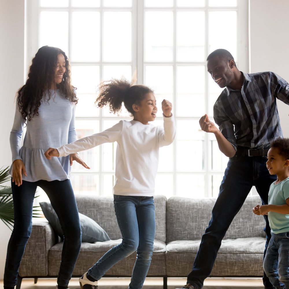 family dancing in living room